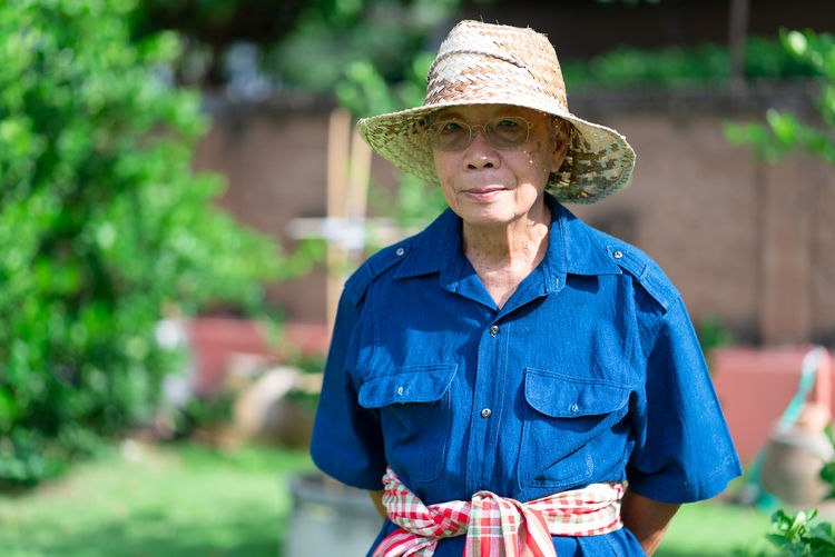 Portrait of senior asian farmer with smiling face standing in farm