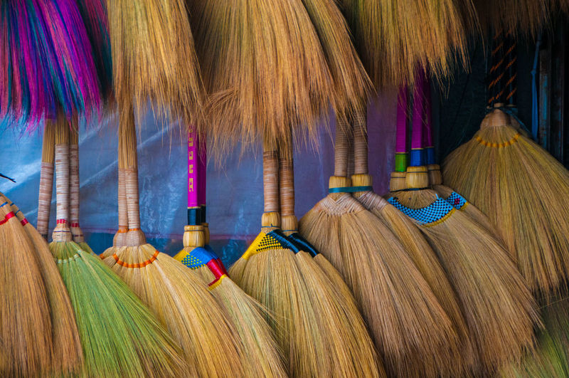 Close-up of brooms for sale at market stall