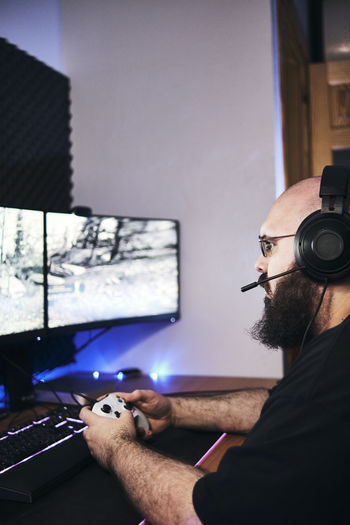 Gamer holding gamepad, controller console in hands. close up.