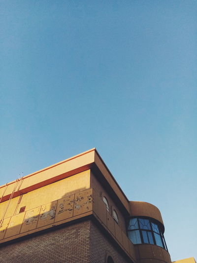 Low angle view of building against clear blue sky