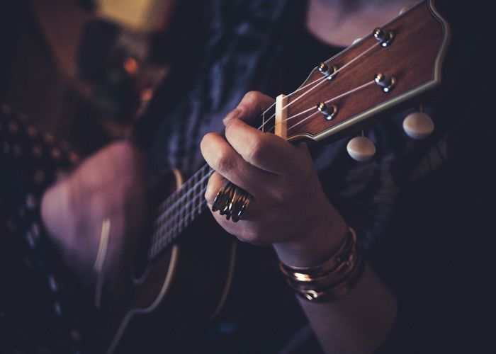 Cropped image of hand holding guitar