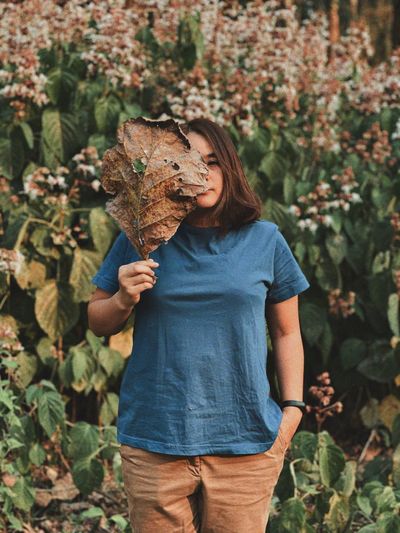 Midsection of woman holding plant