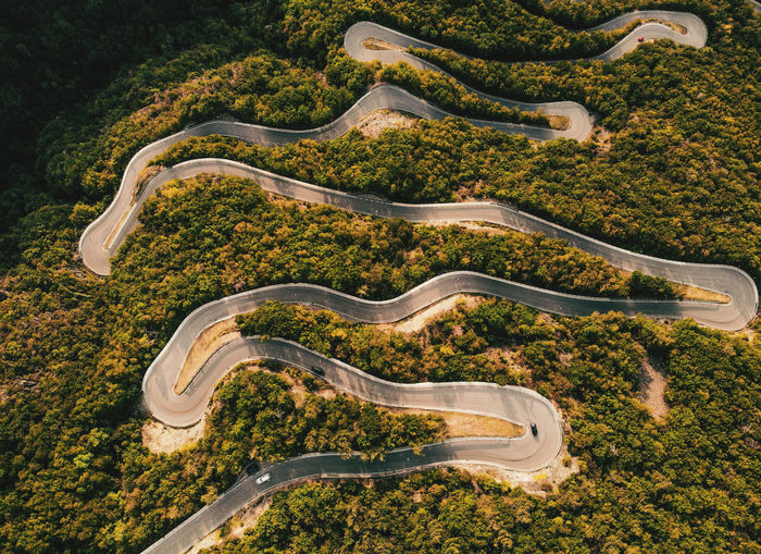 Bird eye view of a funny curvy road trough the forest