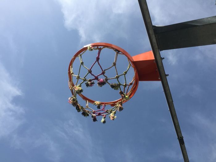 Low angle view of basketball net against the blue sky