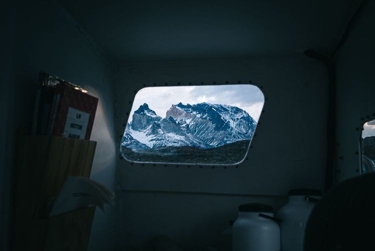 View of snowcapped mountain seen through car window