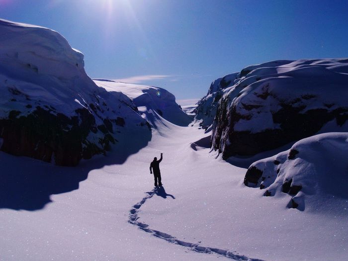 Tourist on snow covered mountain