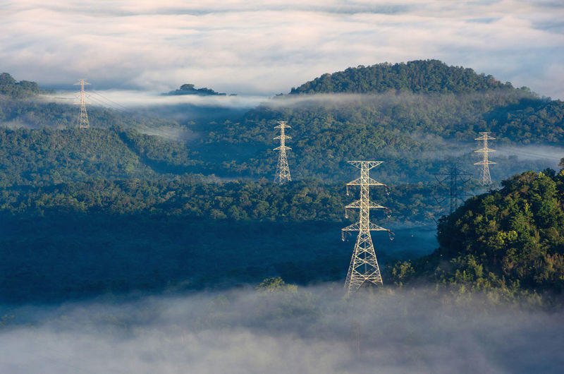 Morning smooth fog. energy and environment concept. high voltage power poles.