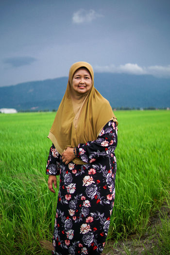 Young woman standing on field