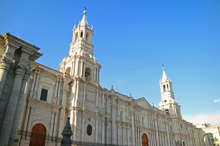 Low angle view of historical arequipa church  against blue sky, peru