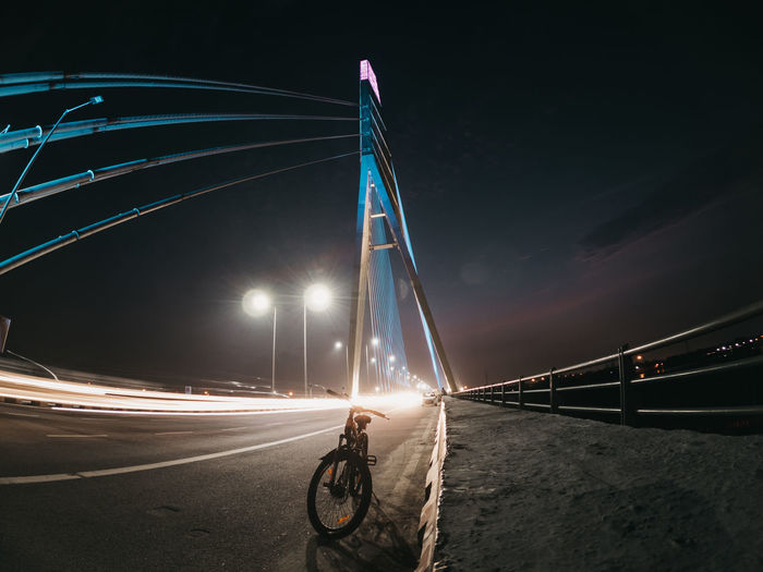 View of illuminated bridge against sky at night