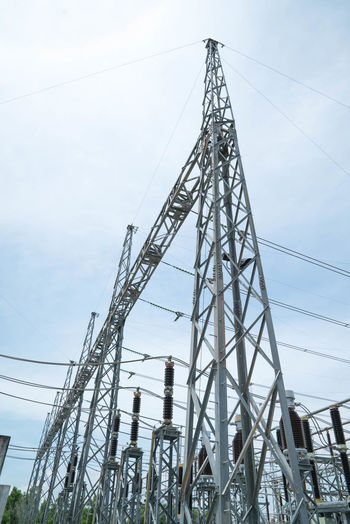 Low angle view of electricity pylon against clear sky