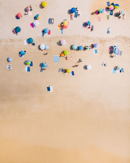Top down view from a beach with beach umbrellas