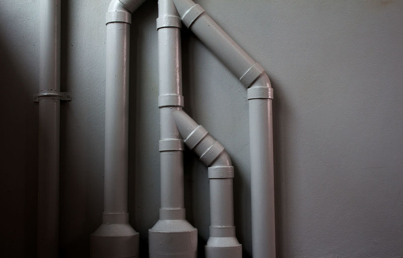 Close-up of water pipes against wall