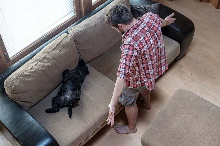 High angle view of man with dog at home