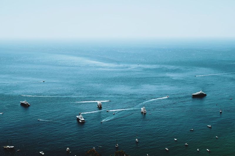High angle view of sailboats in sea against sky