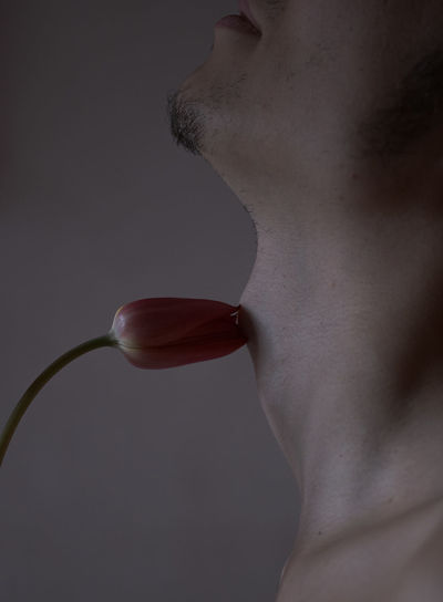 Close-up of young man with tulip 