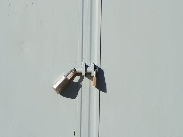 Close-up of door handle on white wall