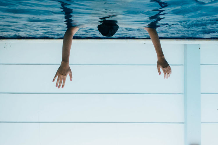 Upside down image of person in swimming pool