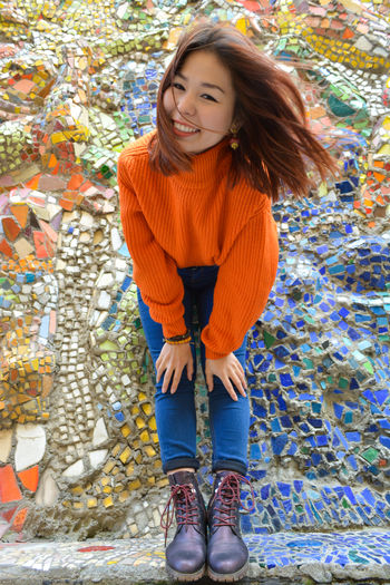 Portrait of smiling young woman standing during autumn