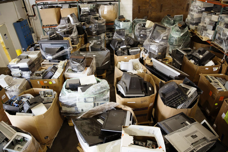 High angle view of various electrical equipments in boxes at recycling plant