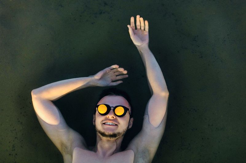 Portrait of young man wearing swimming goggles