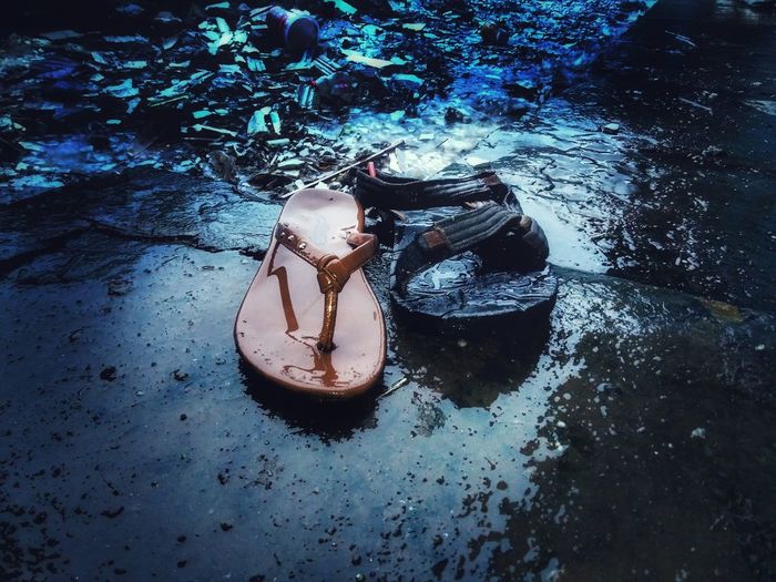 High angle view of shoes on abandoned water