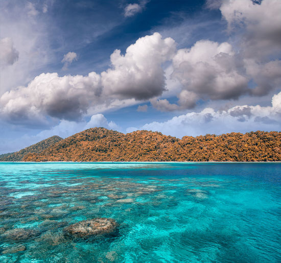 Scenic view of island in sea against sky