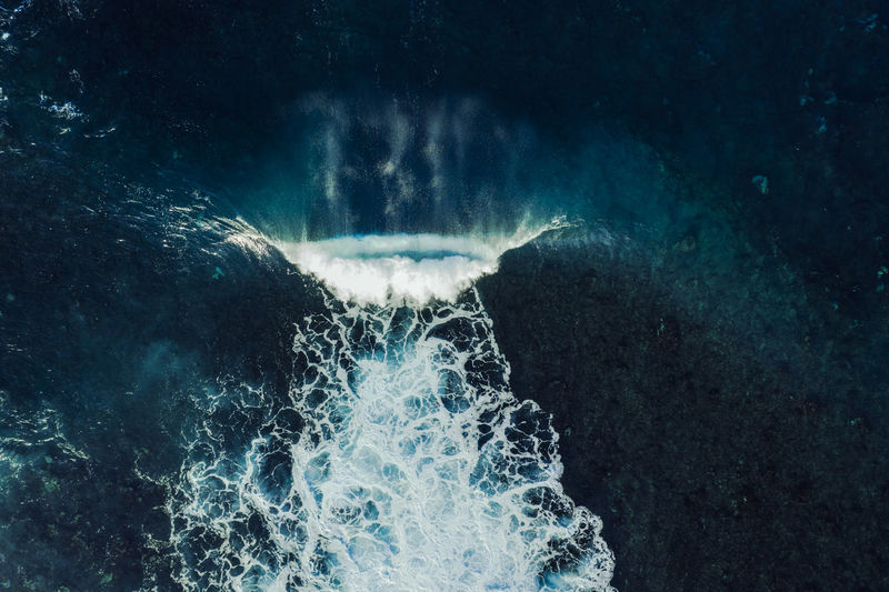 Aerial view of a perfect wave breaking over a lava reef in tenerife