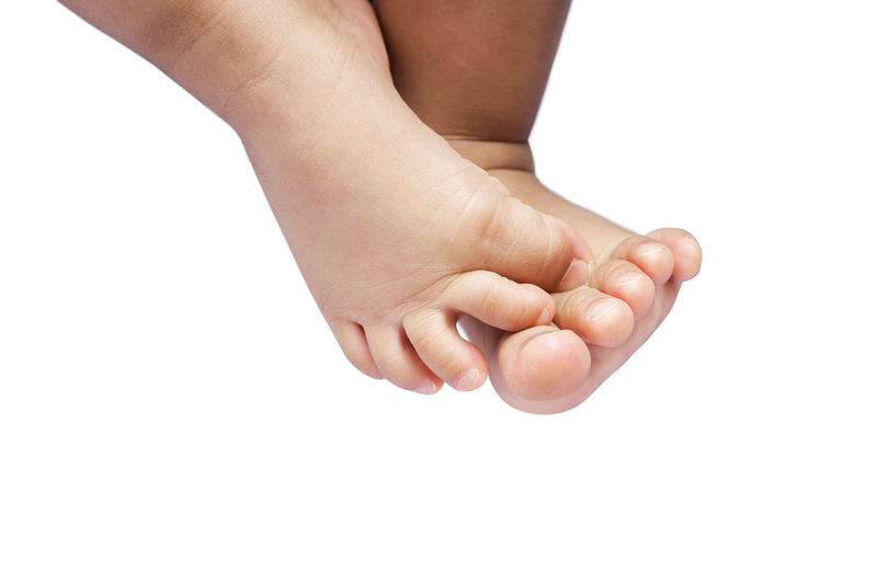 Low section of woman feet on white background