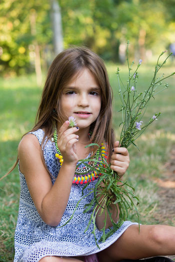 Portrait of a girl holding plant