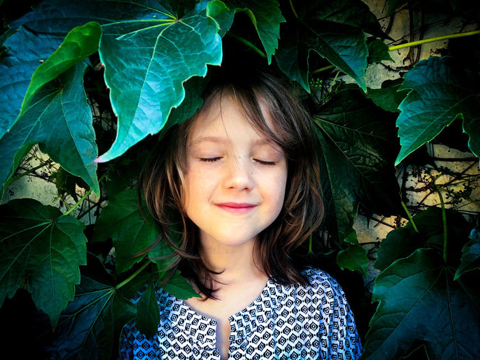 Portrait of smiling girl with leaves