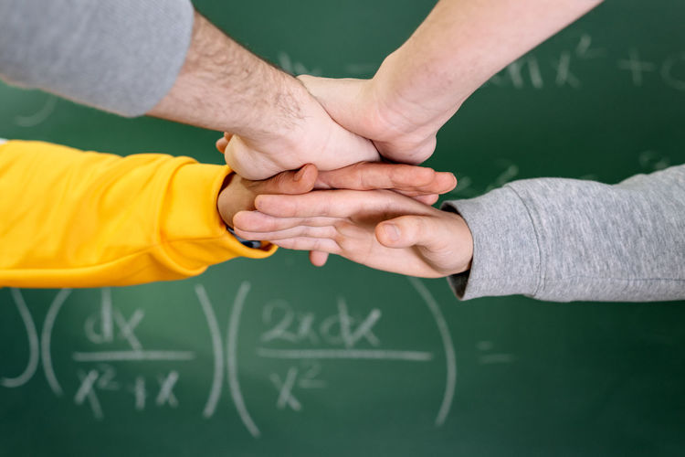 Cropped image of people stacking hands