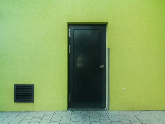 Closed door of green building