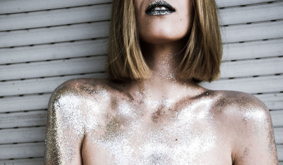 Close-up of young woman with glitter
