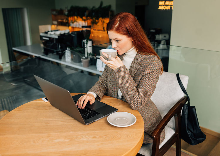 Young woman using laptop at table