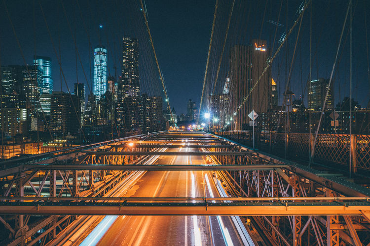 Bridge over road in city at night