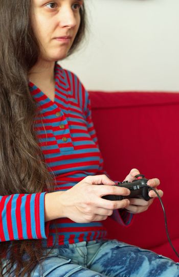 Portrai of young woman playing video games