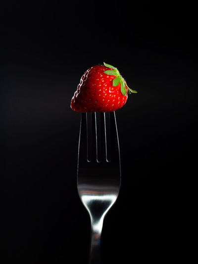 Close-up of strawberry over black background