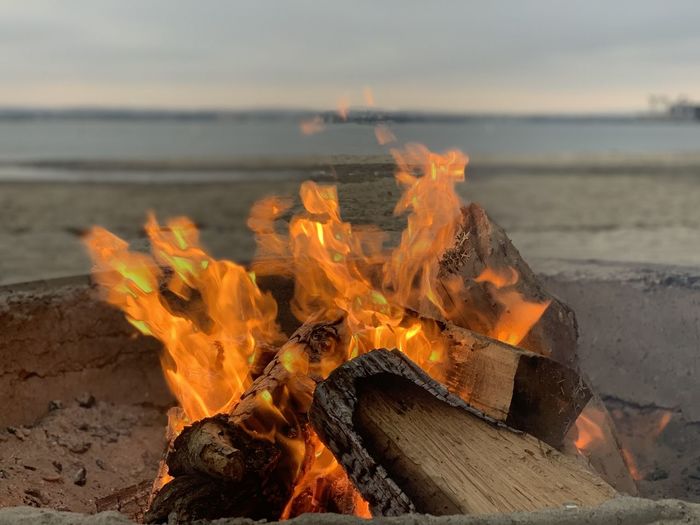 Bonfire on beach against sky