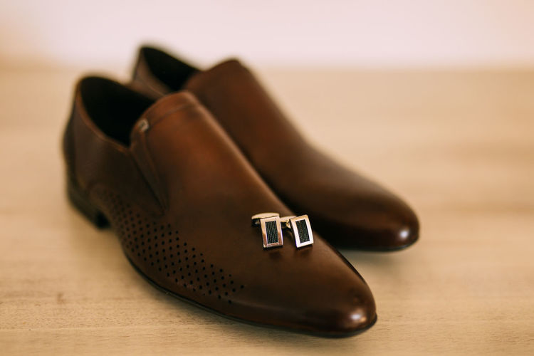 Close-up of shoes and cuff links