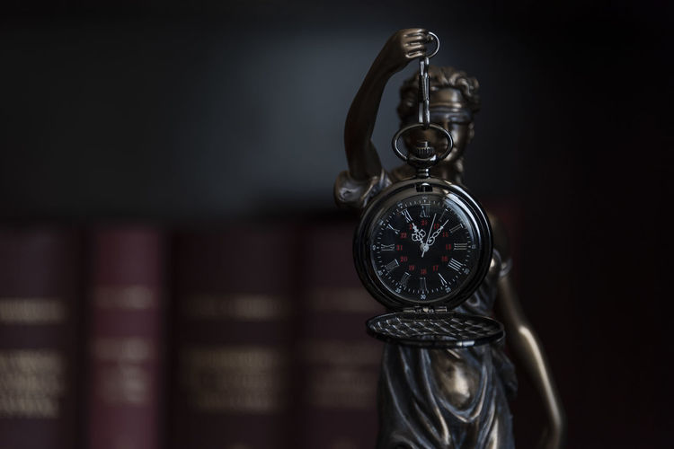 Close-up of pocket watch against black background