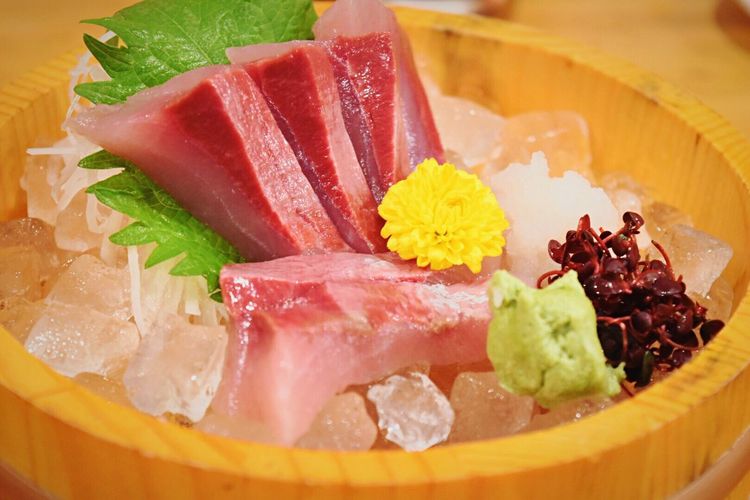 Sashimi with ice in container