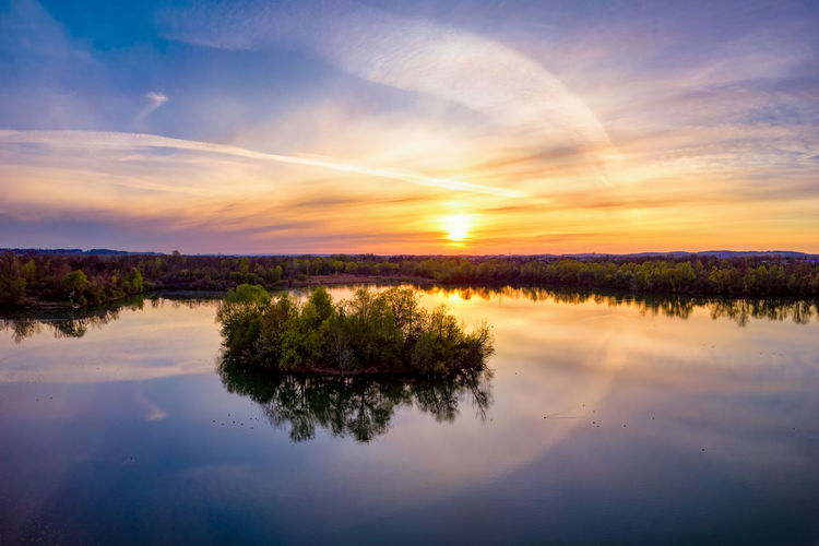 Scenic view of lake against sky during sunset