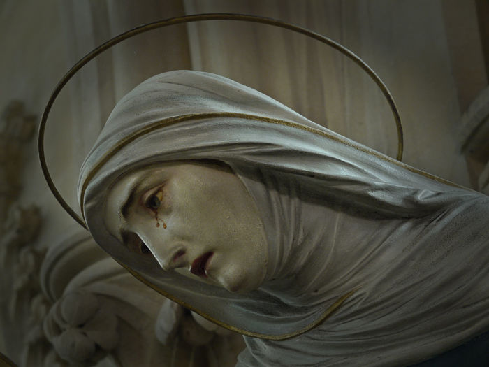 Close-up of crying virgin mary statue at church