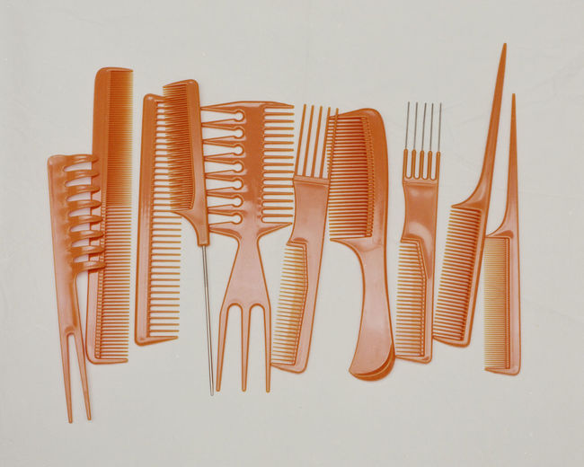High angle view of combs on table against white background