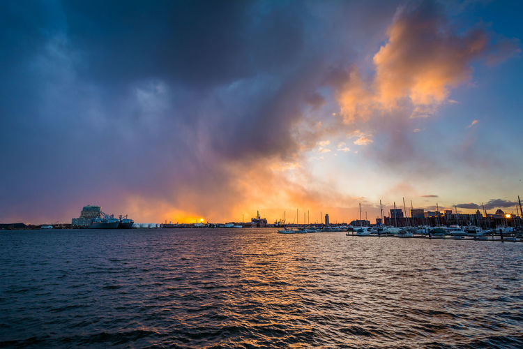 Panoramic view of sea and buildings against sky during sunset