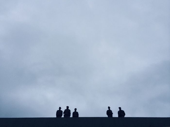 Silhouette people looking at sky