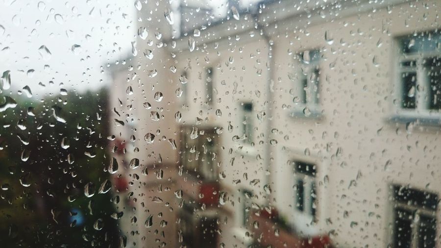 Full frame shot of wet glass window during rainy season