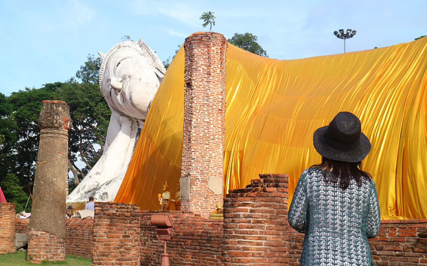 Female looking largest reclining buddha in thailand at wat khun inthapramun temple in ang thong