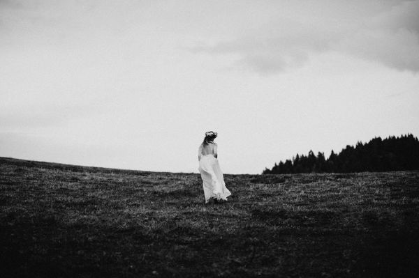 Woman walking on landscape against sky